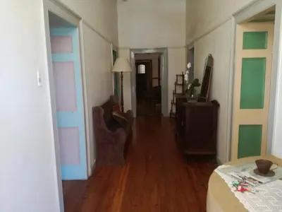 a living room with a room with a hard wood floor at House On Plein in Paarl