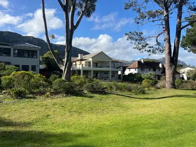 a house with a yard with trees and grass at Golfers delight in Hermanus
