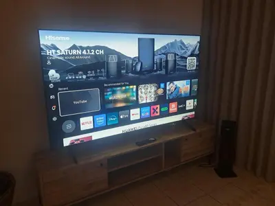 a large flat screen tv sitting on a wooden stand at Salt & Sandy Shores Dolphin Beach Blouberg in Cape Town