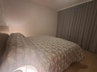 a bedroom with a bed with a white comforter at Salt & Sandy Shores Dolphin Beach Blouberg in Cape Town