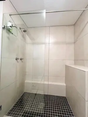 a bathroom with a shower with a glass door at The Hideaway on Moringa Way in Cape Town