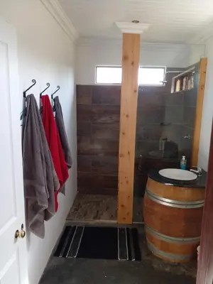 a bathroom with a barrel and a sink and a toilet at Groendraai PetFriendly SelfCatering Accommodation, Die Karoohuis, Die Wijnhuis and Die Vinknes