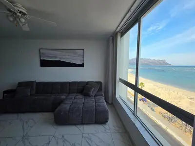 a living room with a couch and a view of the beach at 607 Odean - Luxury Ocean Escape in Strand