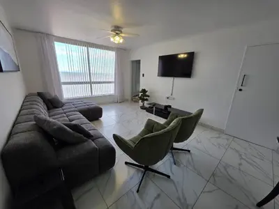 a living room with a couch and two chairs at 607 Odean - Luxury Ocean Escape in Strand