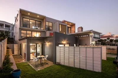 a view of a house with a fence at House Indlovu in Hermanus