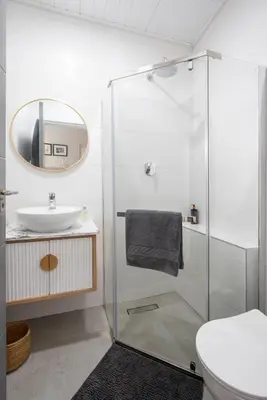 a bathroom with a shower and a sink at House Indlovu in Hermanus