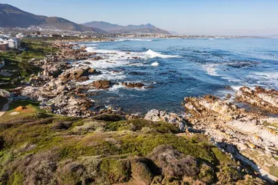 a view of the ocean from a rocky coast at House Indlovu in Hermanus