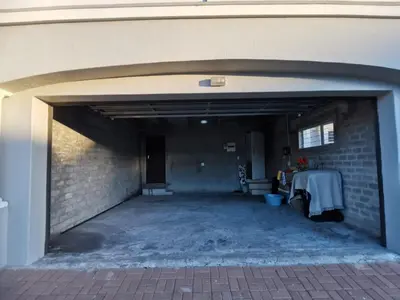 an empty parking garage with a brick wall at Cosy 3 bedroom in Cape Town