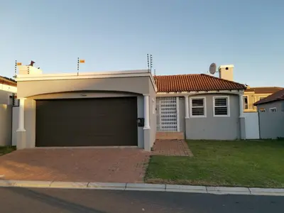 a house with a garage in front of it at Cosy 3 bedroom in Cape Town