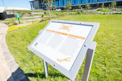 a sign in the grass next to a field at 404 Riverlands - Studio Apartment with Parking in Cape Town