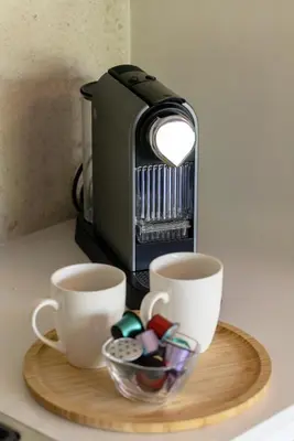 a coffee maker and two cups on a table at The Ya Ya Apartment in Stellenbosch