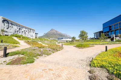 a brick pathway with a mountain in the background at 207 Riverlands - 1 Bedroom Apartment with Parking in Cape Town