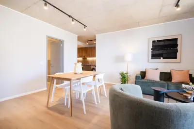 a living room with a table and a couch at 504 Riverlands - Lux 2 Bedroom Apartment with Parking in Cape Town