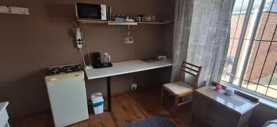 a small kitchen with a desk and a counter top at Pug's Room in Welgemoed