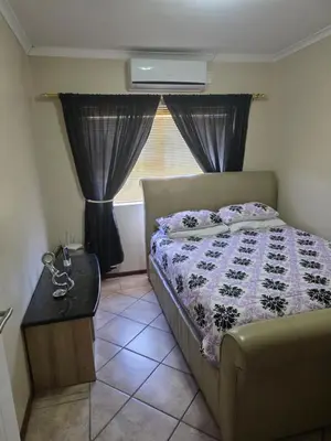 a small bedroom with a bed and a window at Peters Place