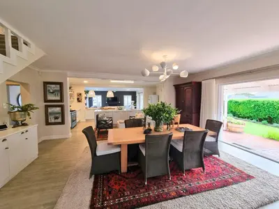 a dining room and kitchen with a table and chairs at Moonlight in Hermanus