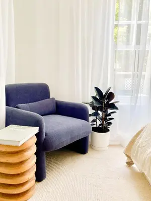 a living room with a blue chair and a plant at Mountain views oasis in Franschhoek