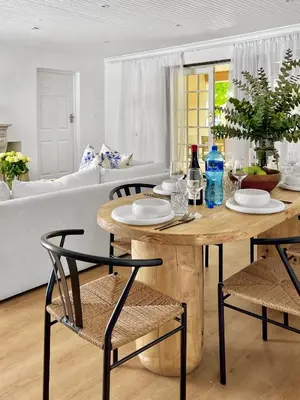 a wooden table and chairs in a living room at Mountain views oasis in Franschhoek