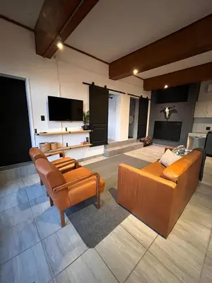 a living room with two couches and a flat screen tv at Durr's Nest - Central Paarl Mountain Retreat in Paarl
