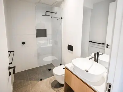 a bathroom with a toilet and a sink and a shower at Ocean 9 Beachfront Residence in Cape Town