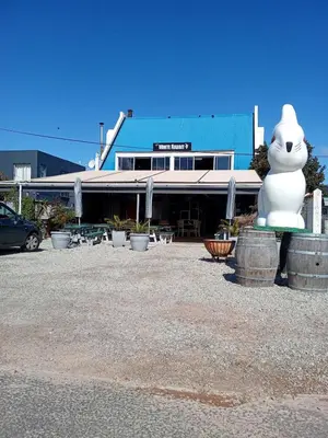 a large white cat statue in front of a building at Paul's Place in Fisherhaven