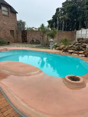 a large swimming pool in a yard at Daisy Accommodation & Spa in Cape Town