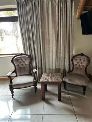 two chairs and a table in front of a window at Daisy Accommodation & Spa in Cape Town