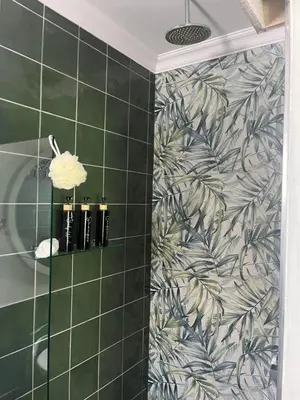 a bathroom with green tiled walls and a shower at carol close1 small apartment in Eversdal