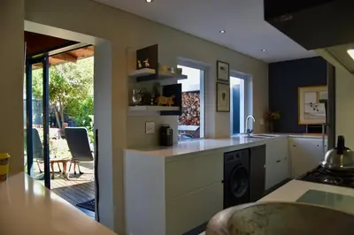 a kitchen with a sink and a counter top at The Modest Mansion in Cape Town