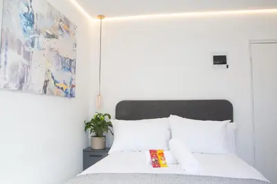 a bedroom with a bed with white pillows at Willow Brooks in Cape Town