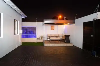 a patio of a house at night with a bench at Willow Brooks in Cape Town