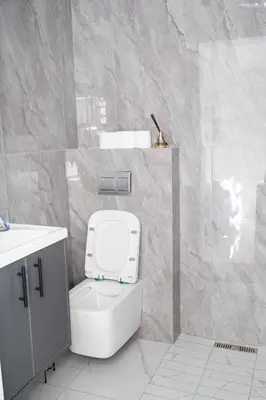 a white bathroom with a toilet and a sink at Willow Brooks in Cape Town