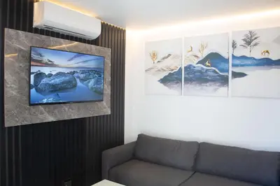 a living room with a couch and three pictures on the wall at Willow Brooks in Cape Town