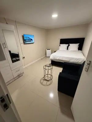 a bedroom with a bed and a couch in it at Joy House in Cape Town