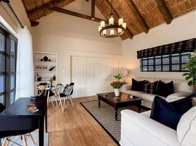 a living room with a white couch and a table at AFRICA WILD HERMANUS Luxury Self Catering Accommodation in Hermanus