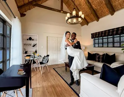 a bride and groom posing for a picture in a living room at AFRICA WILD HERMANUS Luxury Self Catering Accommodation in Hermanus