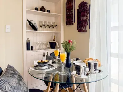 a glass table with food and drinks on it at AFRICA WILD HERMANUS Luxury Self Catering Accommodation in Hermanus