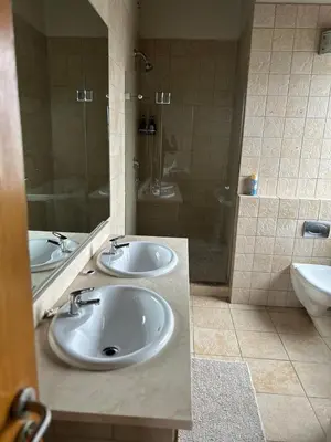 a bathroom with two sinks and a shower at Daisy Accomodation and Spa 5 Bed all private en-suite in Cape Town