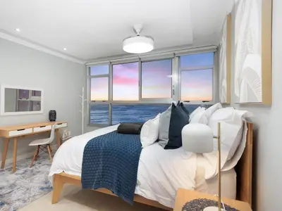 a bedroom with a bed with a view of the ocean at Sandy Shores On Beach - 709 in Strand