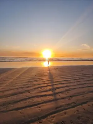a person walking on the beach at sunset at Panorama Sea and Mountain Views in Strand