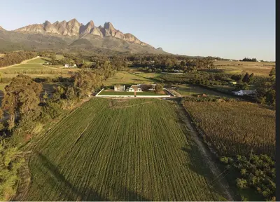 an aerial view of a farm with mountains in the background at Villa Canetsfontein in Wellington