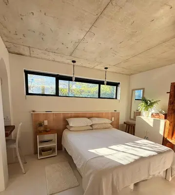 a bedroom with a large bed and a window at Tranquille Haven - serene escape in Franschhoek in Franschhoek
