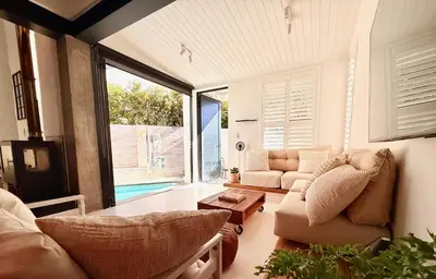 a living room with a couch and a table at Tranquille Haven - serene escape in Franschhoek in Franschhoek