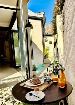 a table with food and drinks on a patio at Tranquille Haven - serene escape in Franschhoek in Franschhoek