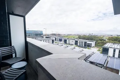 a balcony with chairs and a view of a city at 714 Riverlands - Lux Studio Apartment in Cape Town