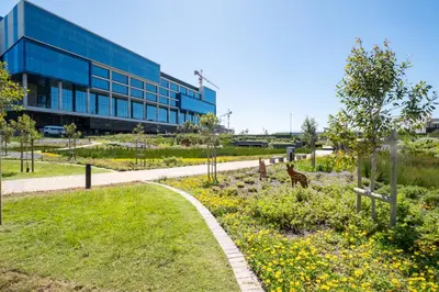 a building with a garden in front of a building at 714 Riverlands - Lux Studio Apartment in Cape Town