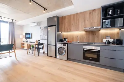a kitchen with a washer and dryer in a room at 309 Riverlands - Lux 1 Bedroom Apartment in Cape Town