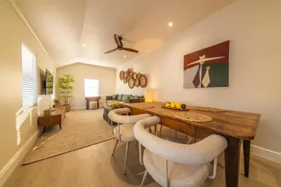 a living room with a dining room table and chairs at The Nest Franschhoek in Franschhoek