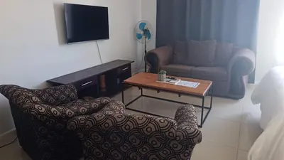 a living room with a couch and a coffee table at Relaxing Hideaway in Strand