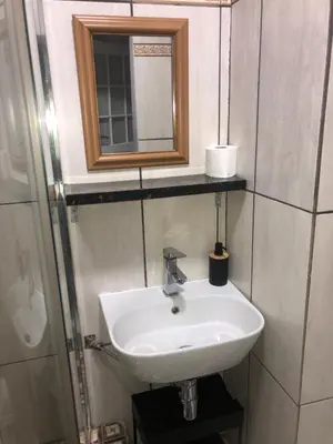 a bathroom with a white sink and a mirror at Relaxing Hideaway in Strand